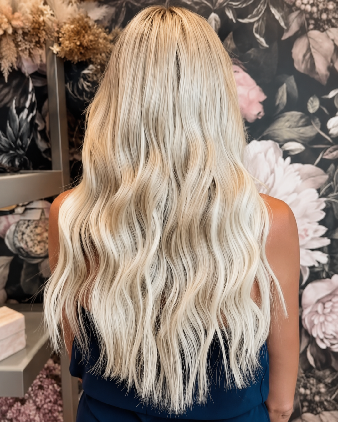 Client showing long brunette hair extensions with caramel highlights, back view