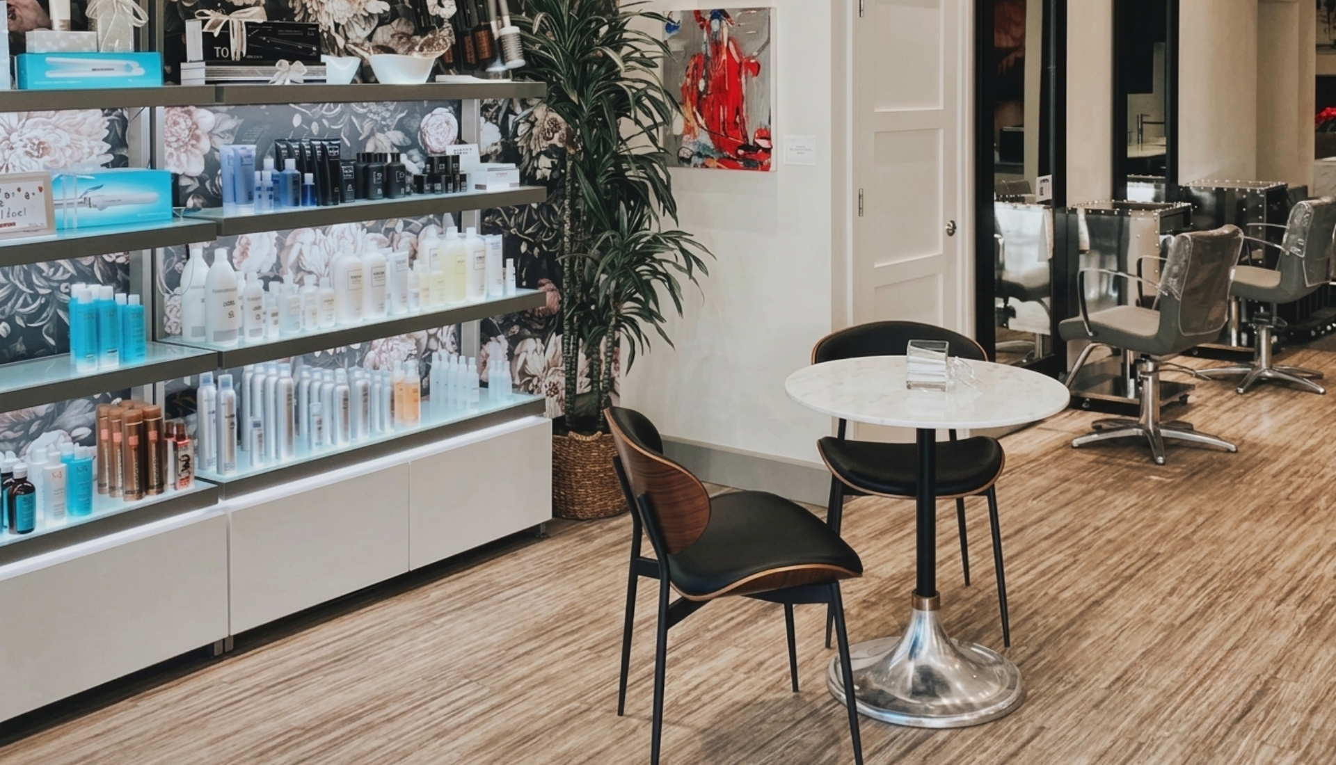 Interior of Exsalonce hair salon showing retail product shelving and styling stations